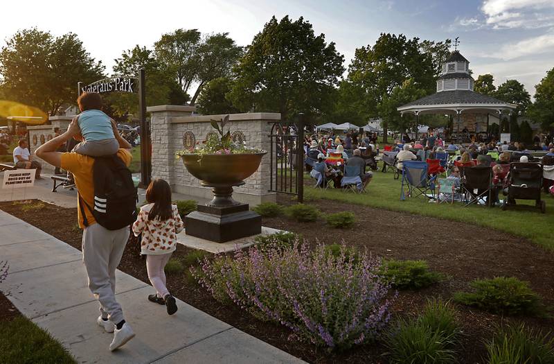 People enjoy the music of the Pino Farino Band on Thursday, May 16, 2024, during McHenry's Pearl Street Market and concert at Veteran's Memorial Park. The market features around 35 venders and live music on Thursdays through Sept. 19.