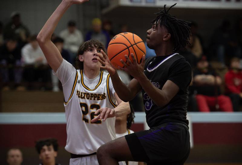 Manteno’s Ray Lee elevates for a layup as Joliet Catholic Academy’s Elias Passehl guards during Saturday’s Kankakee Holiday Tournament blue division title game at Kankakee High School.