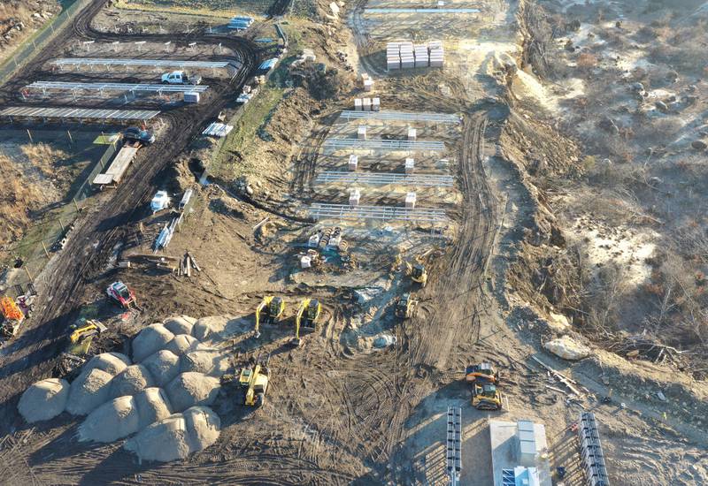 Crews prepare to erect a glass panel on the solar farm located in the 1400 block of North 27th Road (Dee Bennett Road) on Wednesday, Jan. 8, 2026 in Naplate.