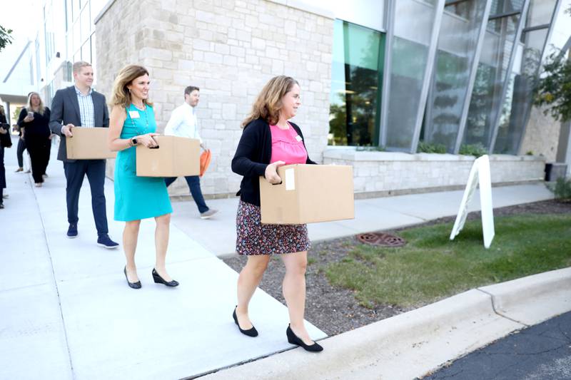 State Rep. Maura Hirschauer, D-Batavia (right), Northern Illinois Food Bank President and CEO Julie Yurko (center) and State Rep. Tom Demmer, R-Dixon, carry boxes of food in honor of the Day of Service at the Northern Illinois Food Bank and highlighting Project Dash's impact on the community. Since May 2021, Northern Illinois Food Bank has partnered with Door Dash and Project DASH for the delivery of charitable food in a way that emphasizes convenience and dignity for its clients.