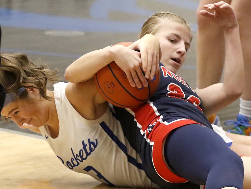 Burlington Central's Savannah Scheuer battles for a loose ball with Belvidere North's Brooke Bottcher on Monday, Nov. 13, 2023, during pool play girls basketball game in the Burlington Central Mark Einwich Tournament.