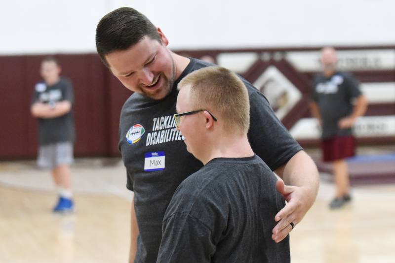 Watseka football coach Max Fransen, left, talks with Evan Hudson at the school's Tackling Disabilities football camp Saturday, July 26, 2025.