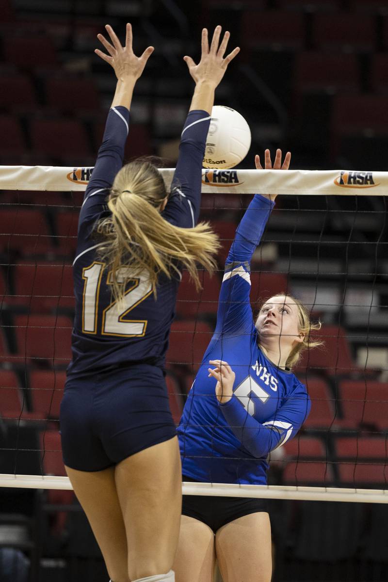 Newman’s Molly Olson hammers the ball against Aquin’s Lucy Arndt Friday, Nov. 11, 2022 in a class 1A volleyball semifinal.