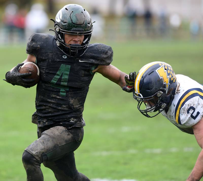Joe Lewnard/jlewnard@dailyherald.com
Glenbard West’s Julius Ellens, left, gets past Glenbrook South’s Charlie Gottfred for a first-quarter tocudown during the Class 8A second round football game in Glen Ellyn Saturday.