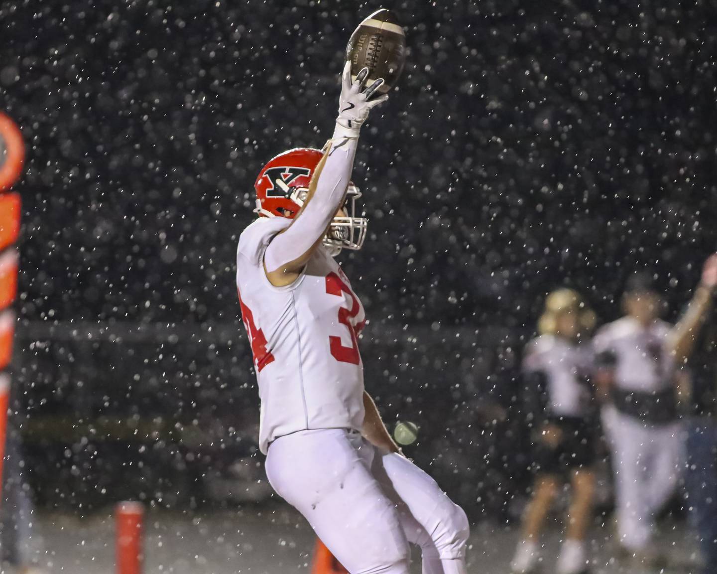 Yorkville's Gavin Geegan (34) holds the ball up after scoring a touchdown during football game between Yorkville at Plainfield East Friday, Sept 19, 2025 in Plainfield.