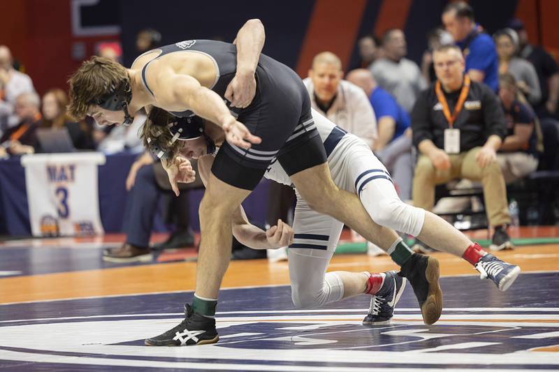 IC Catholic’s Aiden Arnett works against Civic Memorial’s Knox Verbais in the 2A 150 pound title Saturday, Feb. 21, 2026, at the IHSA wrestling finals in Champaign.