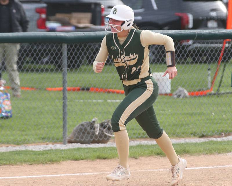 St. Bede's Ella Hermes runs along the third base line with a smile after hitting a monster home run against Marquette on Monday, April 22, 2024 at St. Bede Academy.