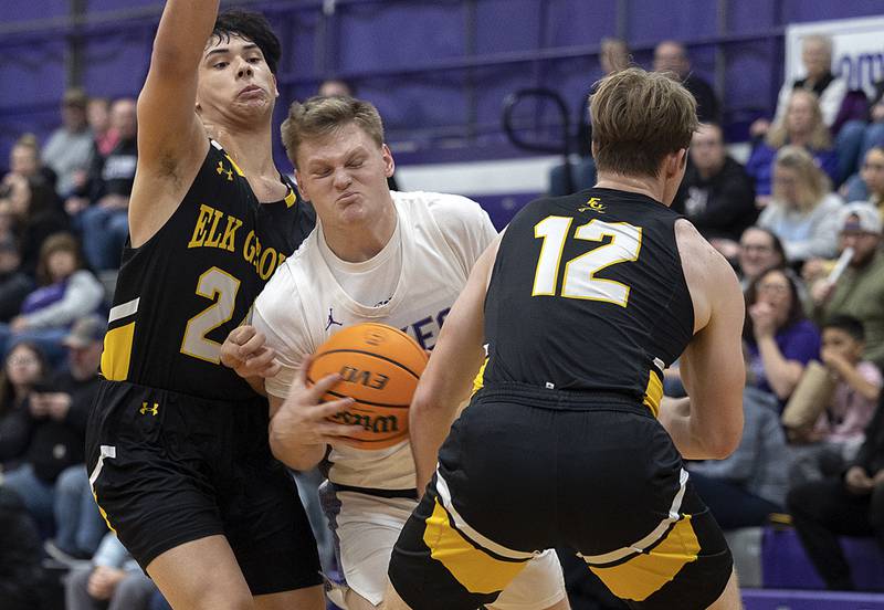 Dixon’s Eli Davidson splits the defense of Elk Grove’s Matt Novak (left) and Dan Pasterski Saturday, Jan. 11, 2025.