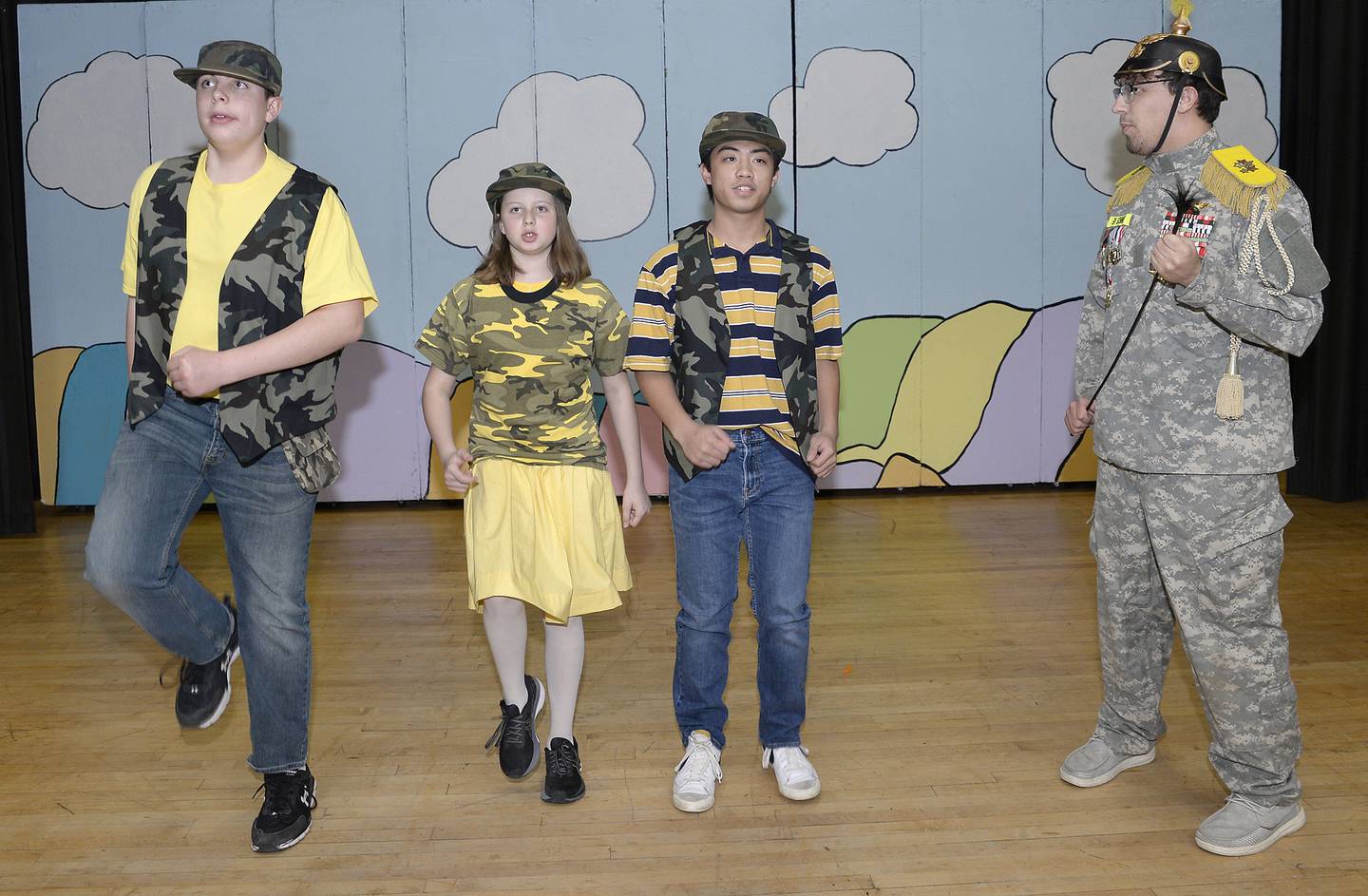 Marquette Academy students (left to right) Frank Reynolds, Ceci Reynolds and Ben Weyer, as Who Cadets, with Rilee Lieske, as General Genghis Khan Schmit, perform in a scene from "Seussical The Musical."
