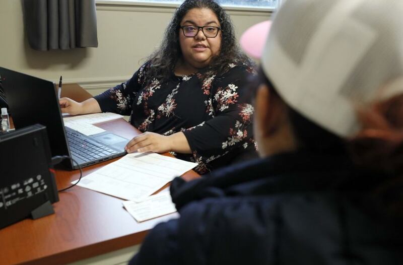 Luz Ramirez, a patient navigator for the DuPage Health Coalition, works with clients in her office in Carol Stream. The nonprofit connects low-income and uninsured DuPage County residents to low-cost health care. (Brian Hill | Staff Photographer)