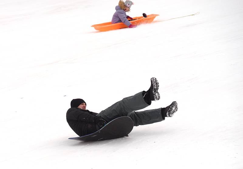 Kids and adults including Ruslan Kalinovskyi of Carol Stream fight the cold temperatures by sledding at Northside park in Wheaton Saturday, Jan 13, 2024.