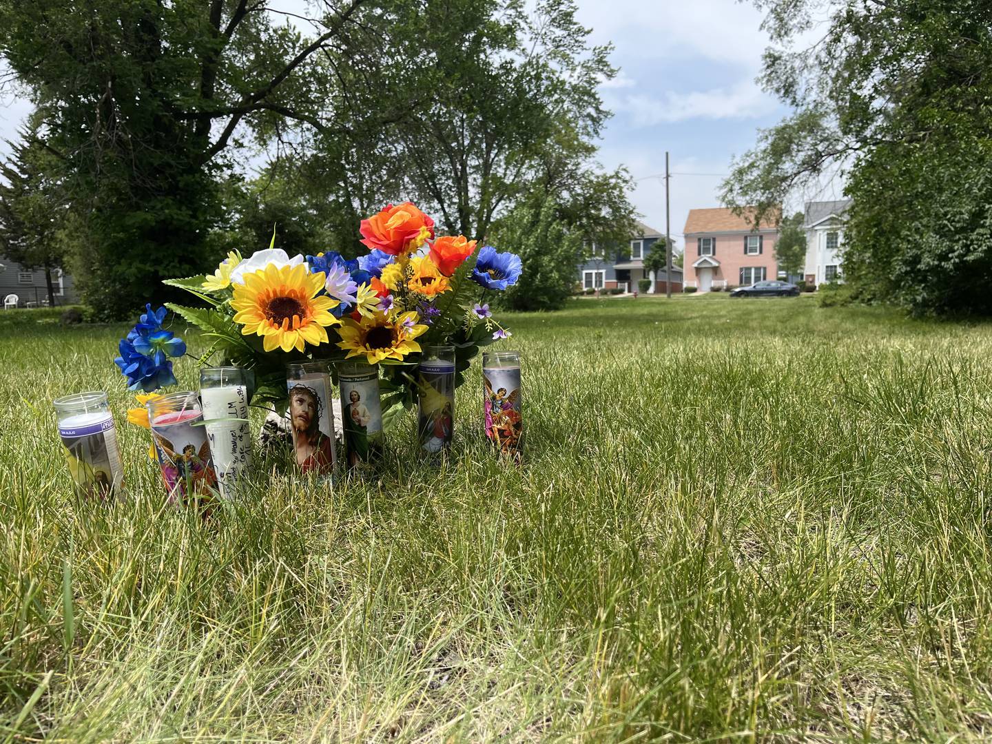 Flower and candles for a 13-year-old boy who was shot and killed on Monday, June 2, 2025, in Joliet.