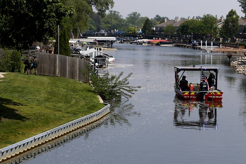 Law enforcement from area departments surround a home on Thursday, June 5, 2025, in the area of Venice Avenue and Court Street in McHenry.