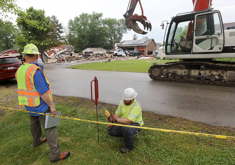 A worker checks for gas leaks near the site of a home explosion on Monday, May 18, 2026, in 7400 block of Birch Drive, in Wonder Lake, after the Sunday evening explosion. One resident of a home was killed  and two others have been taken to the hospital.