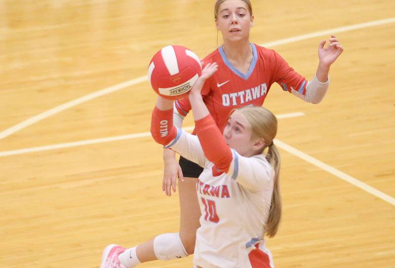 Ottawa's Bailey Etscheid hits the ball in the air as libero Kendall Biba backs her up on Tuesday, Sept. 9, 2025 at Kingman Gymnasium.