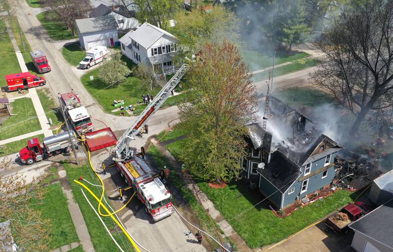 Firefighters from Paw Paw, Somonauk, Troy Grove, Mendota, Earlville, Leland, Utica and Ottawa work the scene of a house fire in the 300 block of Maple Street on Monday, April 22, 2024 in Earlville. The fire happened around 10a.m.