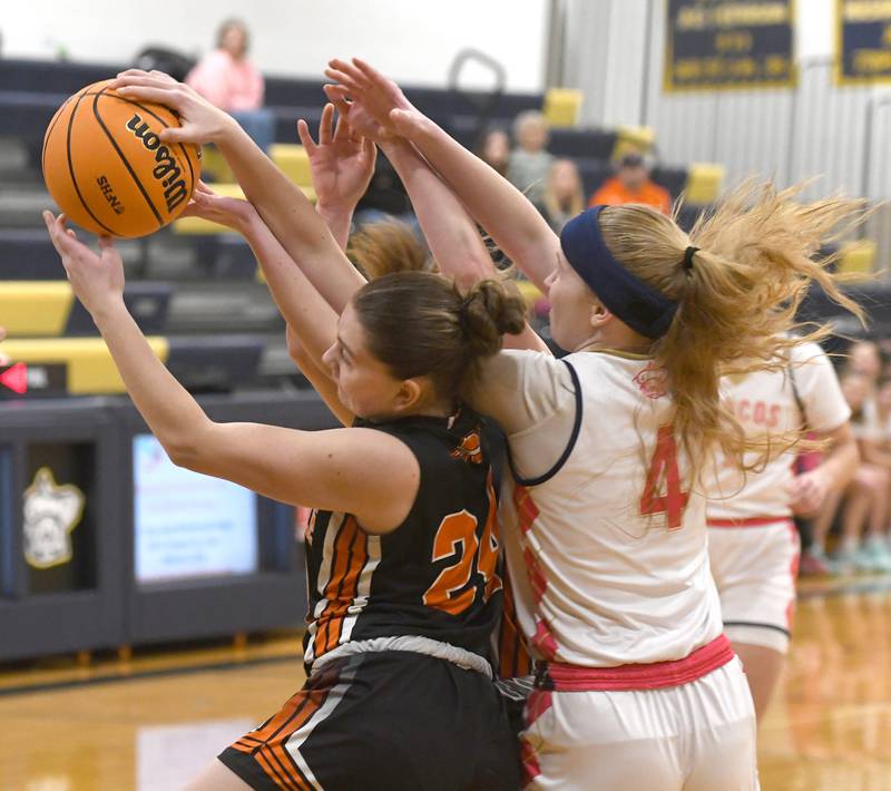 Milledgeville's Jozlynn Castro (24) and Polo's Camrynn Jones (4) battle for a rebound on  Saturday, Jan. 24, 2026 at Polo High School.