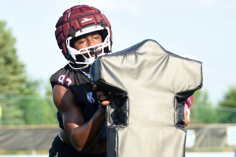 Kankakee's KJ Crite hits the blocking sled during a drill at practice Monday, Aug. 11, 2025.