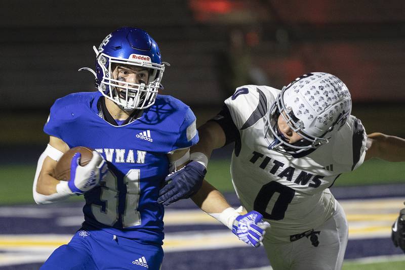 Newman’s Cody McBride looks to pick up yards against Monmouth-Roseville’s Nick Huston Friday, Oct. 25, 2024, at Roscoe Eades Stadium in Sterling.