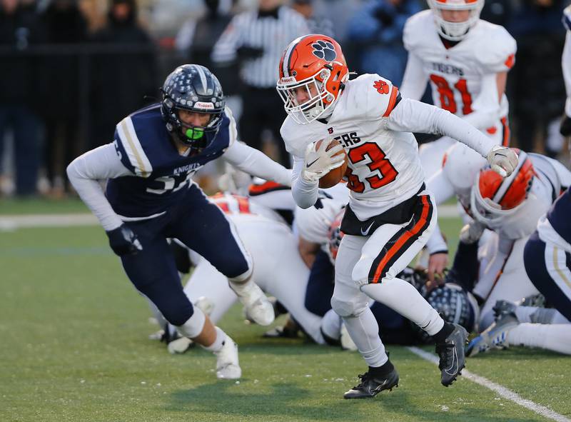 Byron's Carsen Behn (33) runs the ball during the Class 3A varsity football semi-final playoff game between Byron High School and IC Catholic Prep on Saturday, Nov. 19, 2022 in Elmhurst, IL.