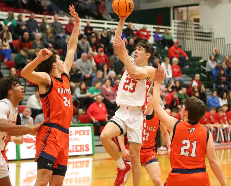 L-P's Nick Olivero cuts in the lane between Pontiac defenders Henry DeYoung and Anderson Horning on Tuesday, Dec. 17, 2024 in Sellett Gymnasium at L-P High School.