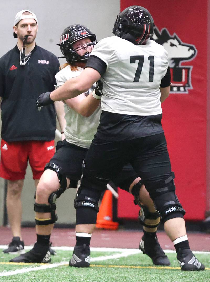 Northern Illinois offensive linemen Evan Buss (left) and Drew Hoth participate in a drill during the teams first spring practice Wednesday, March 22, 2023, in the Chessick Practice Center at Northern Illinois University in DeKalb.