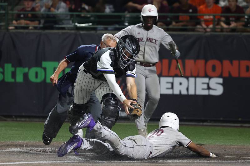 Brother Rice’s Bryce Nevils slides under the late tag by Lincoln-Way East’s Aiden Knipper in the Class 4A Crestwood Supersectional on Monday, June 5, 2023 in Crestwood.