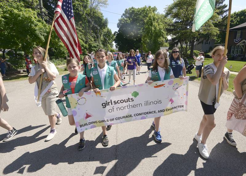 Girl Scouts march down Main Street in Oswego during the annual Memorial Day Parade and Service, Monday, May 29, 2023.