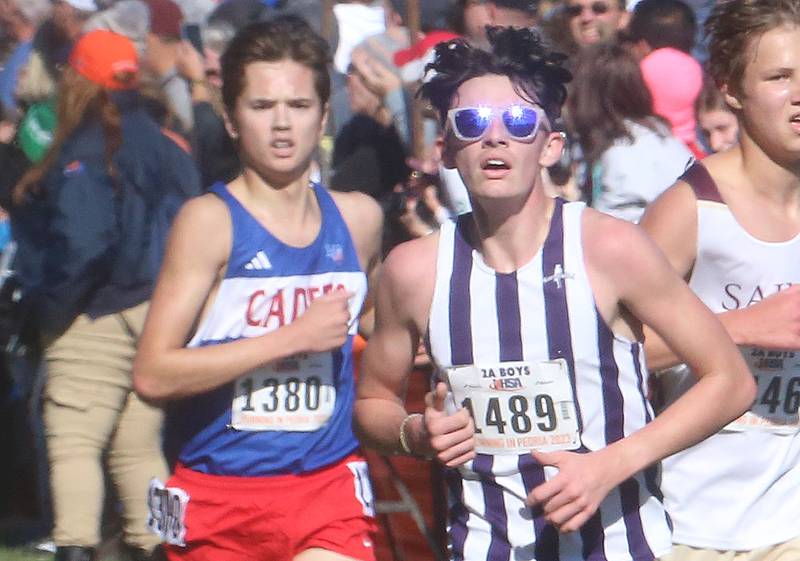 Marmion Academy's Robert Gramley and Dixon's Dean Gieger competes in the Class 2A State Cross Country race on Saturday, Nov. 4, 2023 at Detweiller Park in Peoria.