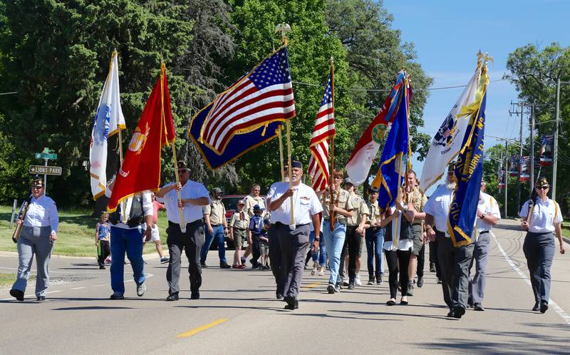 The procession (Elburn American Legion Post 630, Elburn Boy Scout Troop 7 and Elburn Cub Scout Pack 107) for the Memorial Day ceremony marches down Route 47 on Monday, May 29, 2023 in Elburn.