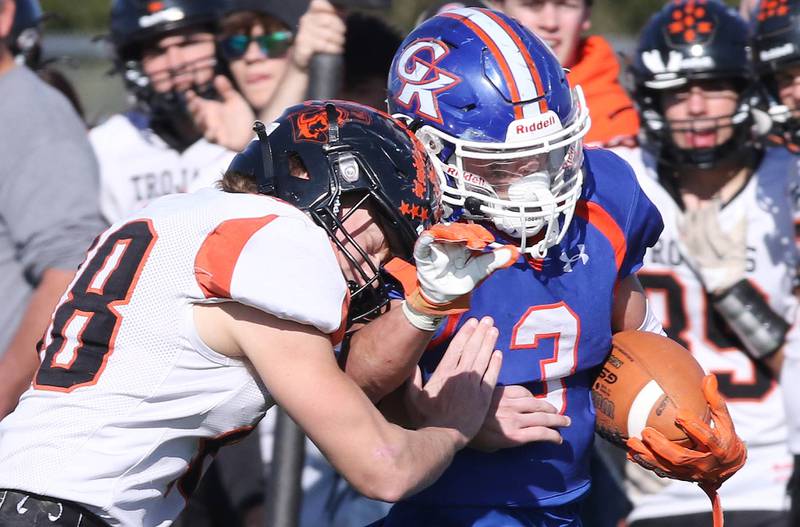 Genoa-Kingston's Brody Engel takes a hit from Elmwood’s Gavin Buhl during their first round playoff game Saturday, Oct. 29, 2022, at Genoa-Kingston High School.