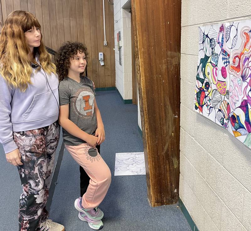 Courtney Engel (left) and Ameliah Sedam admire the geometric abstractions done in ink, Copic markers that were on  display at the BEST Art Show in May.