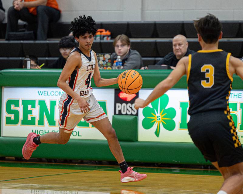 Diego Perez (4) of DePue dribbles ball up court during game against Reed-Custer in the Shipyard Showdown on Tuesday, December 23, 2025 at Seneca High School in Seneca.