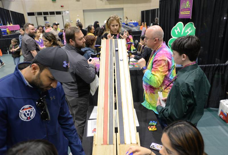Children including Sophia Mangerson of Orland Park get a lesson on friction and texture during the STEMCON event on Saturday April 26, 2025 at the College of DuPage in Glen Ellyn.