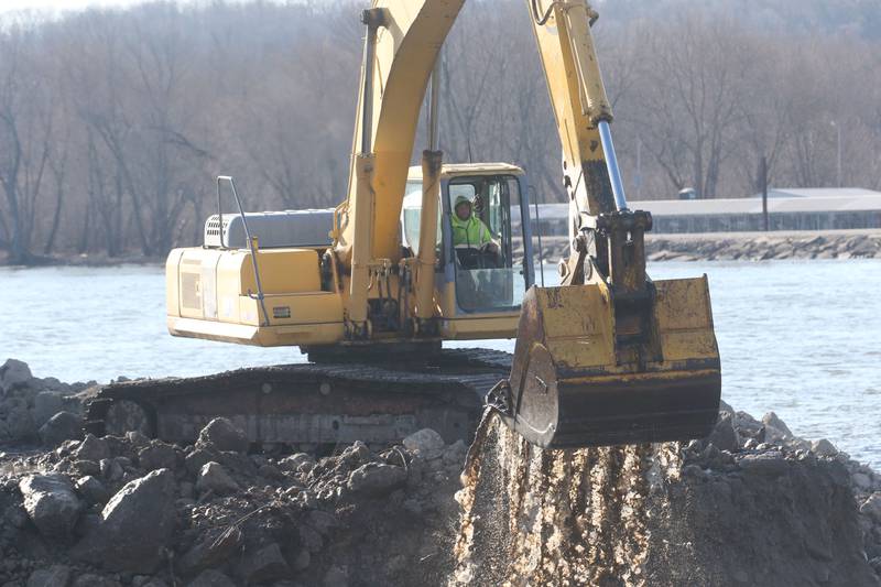 A operator uses an excavator to dredge the harbor at Barto Landing on Wednesday, March 26, 2025 in Spring Valley.