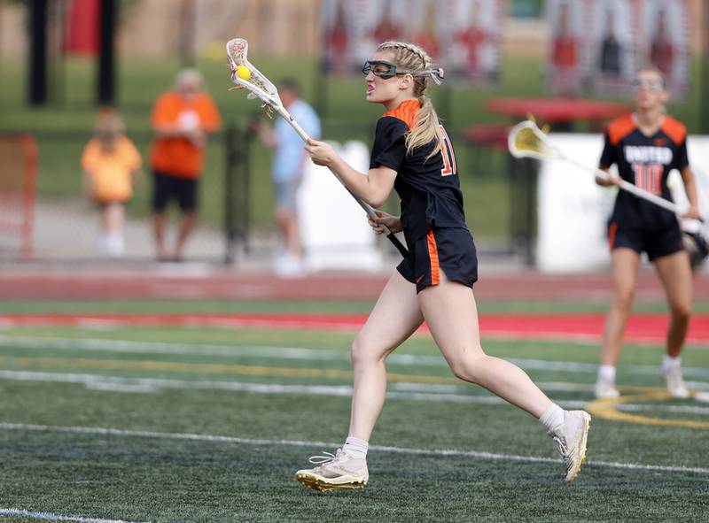 Crystal Lake Central Coop's Ella Trudeau (17) takes the ball down the field during the lacrosse state semi-final match between Crystal Lake Central and Loyola Academy on Thursday, June 5, 2025 in Hinsdale.