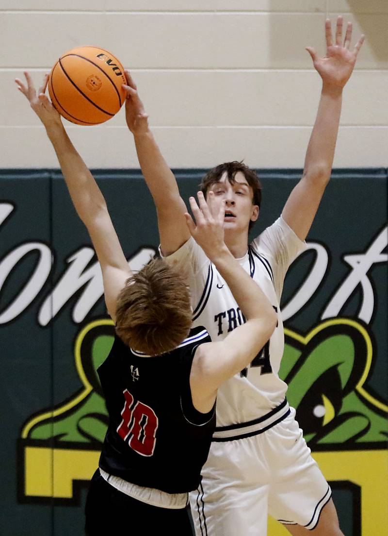 Cary-Grove's Evan Bauer blocks the shot of Marmion's Charlie Dee during an IHSA Class 3A Crystal Lake South Regional boys basketball semifinal game on Wednesday, February, 25, 2026, at Crystal Lake South High School.