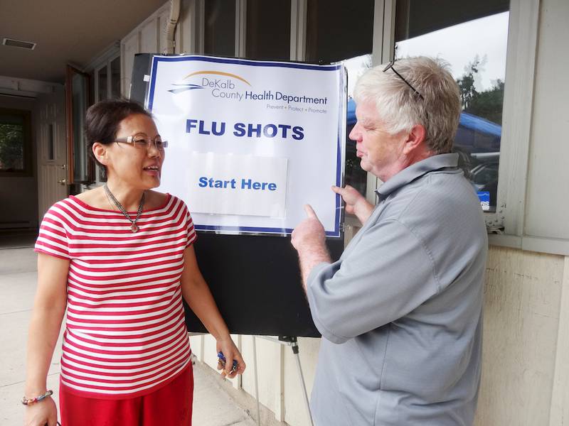 Jim Allen (right), pastor of the Shabbona United Church of Christ, discusses flu shots Lia Grace Aspengren of Shabonna during the open house wellness event of the United Neighborhood Center in Shabbona on Saturday, Sept. 20.