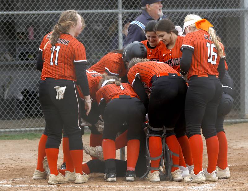 McHenry’s Tatum Kornfeind is mugged by her teammates after hitting a home run during a Fox Valley Conference Softball game Monday, May 2, 2022, between Cary-Grove and McHenry at Cary-Grove High School.