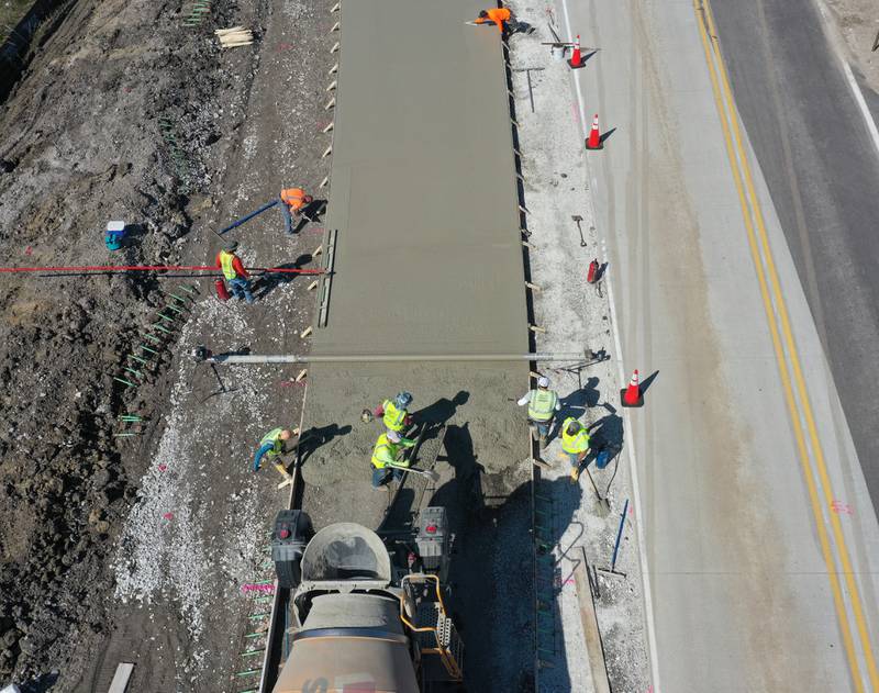 Workers pour a large section on the south side of the roundabout at the intersection of Route 71 and Illinois 178 on Tuesday, April 11, 2023 in Utica.