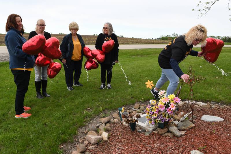 Peggy Lynn Johnson-Schroeder’s family gathered on 92nd Street in the town of Raymond, Wisconsin, where Johnson-Schroeder’s body was found in 1999, to release 10 red balloons, after Linda La Roche was sentenced Monday, May 23, 2022, in Racine County to life in prison without parole for the killing of Johnson-Schroeder in 1999. The property owner maintains the site as a memorial to Johnson-Schroeder. Her family wrote messages to Johnson-Schroeder on the balloons before releasing them.
