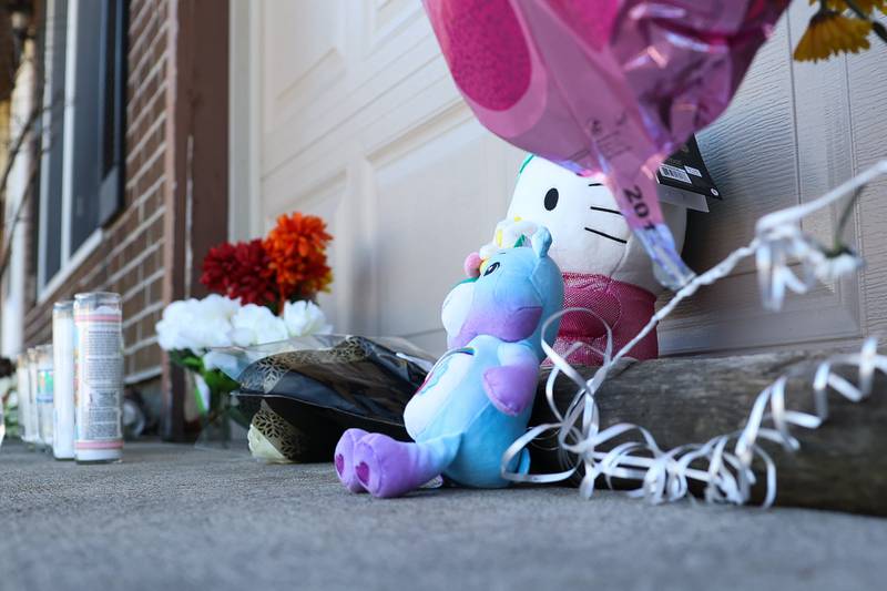 A memorial is set up outside the home along the 100 block of Lee Lane in Bolingbrook the day after a triple homicide.