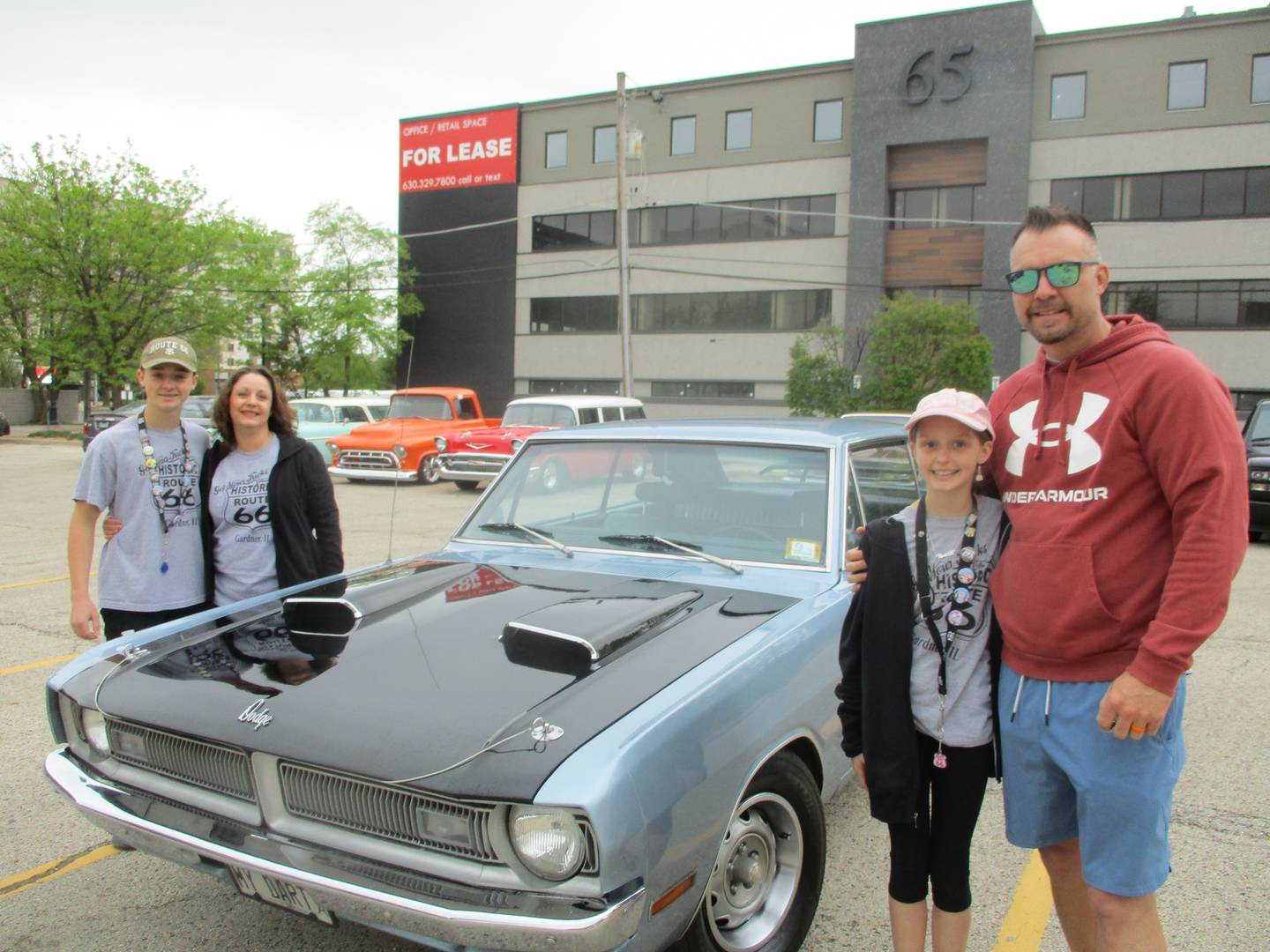 The Perone family of Yorkville. (from left) Aidan, Jody, Emily and Joe, pose for a photograph outside the Joliet Area Historical Museum around the Dodge Dart Swinger that they would take for the Route 66 Red Carpet Corridor Tour on Saturday, May 6, 2023.