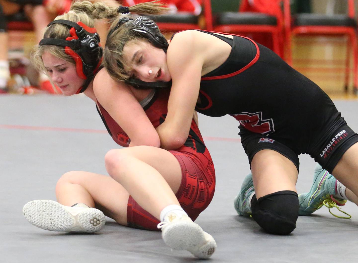 Streator's Lily Gwaltney wrestles L-P's Kiely Domyancich during a meet on Wednesday, Dec. 13, 2023, in Sellett Gymnasium at L-P High School.