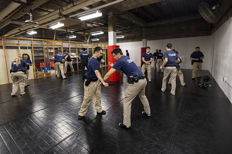 Kenneth Malo (left) and Spencer Shaw work defense of dealing with a subject with a knife Wednesday, July 17, 2024, at the Sauk Valley Police Academy.