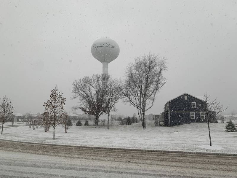 Snow falls the morning of Friday, Dec. 9, 2022, in the Woodlore Estates subdivision in Crystal Lake.