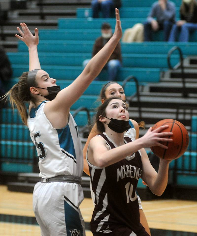 Marengo’s Bella Frohling, right, drives to the basket against Woodstock North's Avery Crabill, left, during the first quarter of a Kishwaukee River Conference girls basketball between Marengo and Woodstock North Wednesday evening, Jan. 12, 2022, at Woodstock North High School.