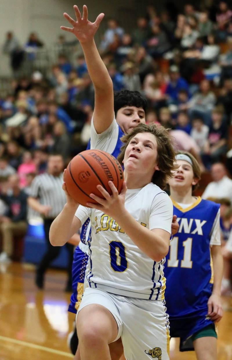Logan eighth-grader Brennan Emmett eyes the hoop during Tuesday's Fight like Erin Night at Prouty Gym against LaSalle Lincoln.