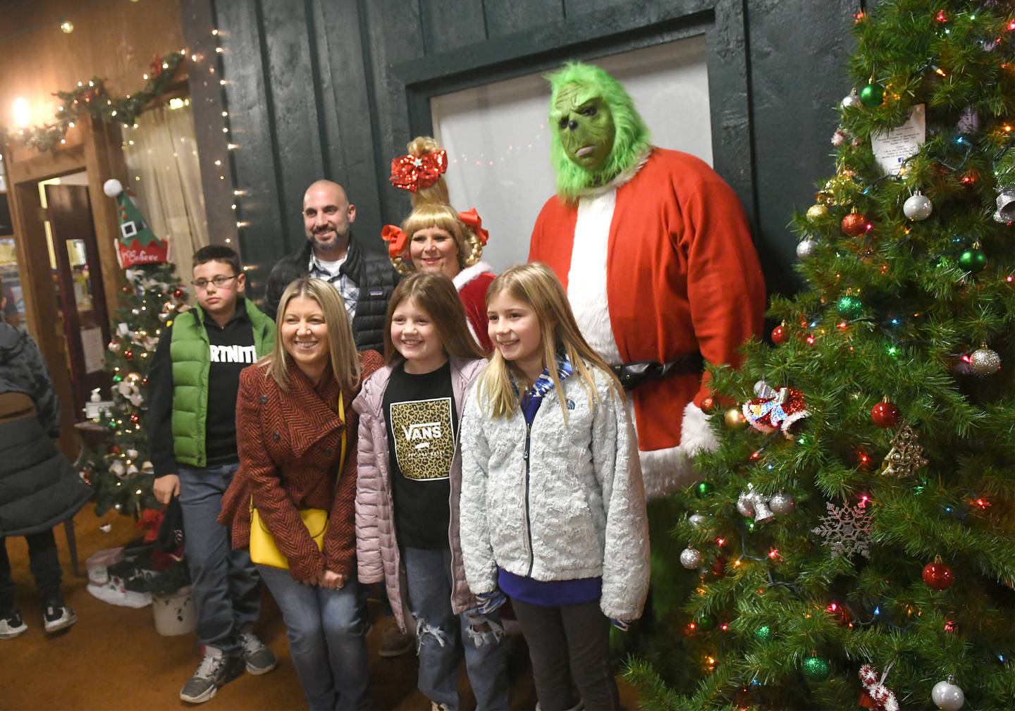 Santa wasn't the only fan favorite in Conover Square during Oregon's Candlelight Walk on Nov. 26. The American Thrift store hosted Grinch and Cindy Lou Who. Here, the Roos family poses for a photo with the Dr. Seuss characters. Pictured are: Hayden Josh, and Amanda Roos, and Cassidy and Sienna Spese.