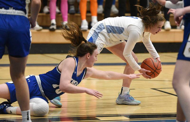 Geneva's Cassidy Arni, left, hits the deck chasing a loose ball with St. Charles North's Alyssa Hughes during Thursday’s girls basketball game in St. Charles.